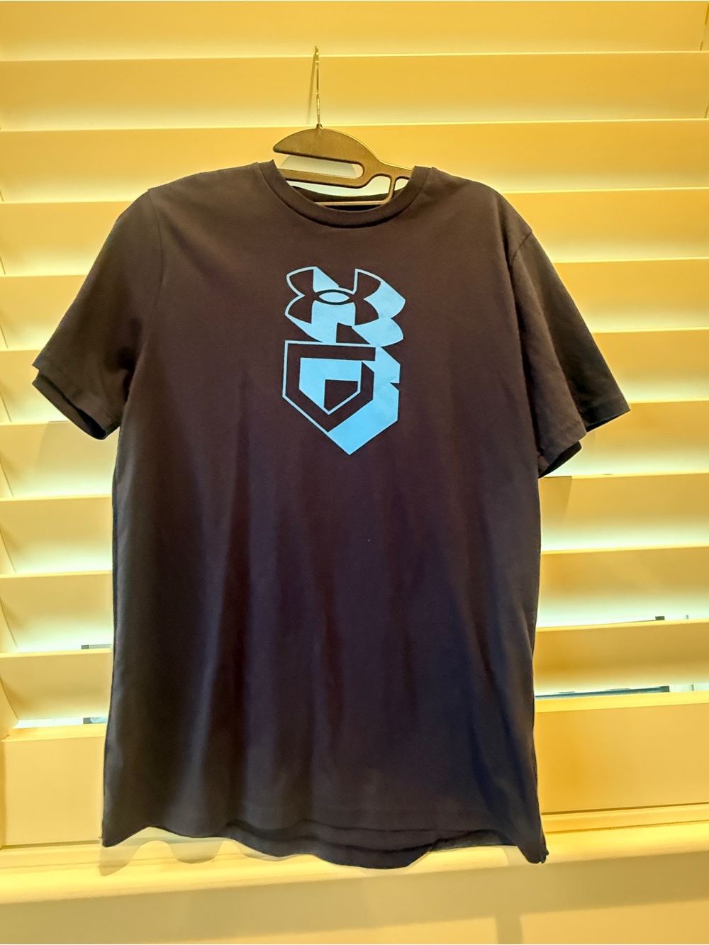 YXL Under Armour Black Short Sleeve Tee with Light Blue Shield Logo